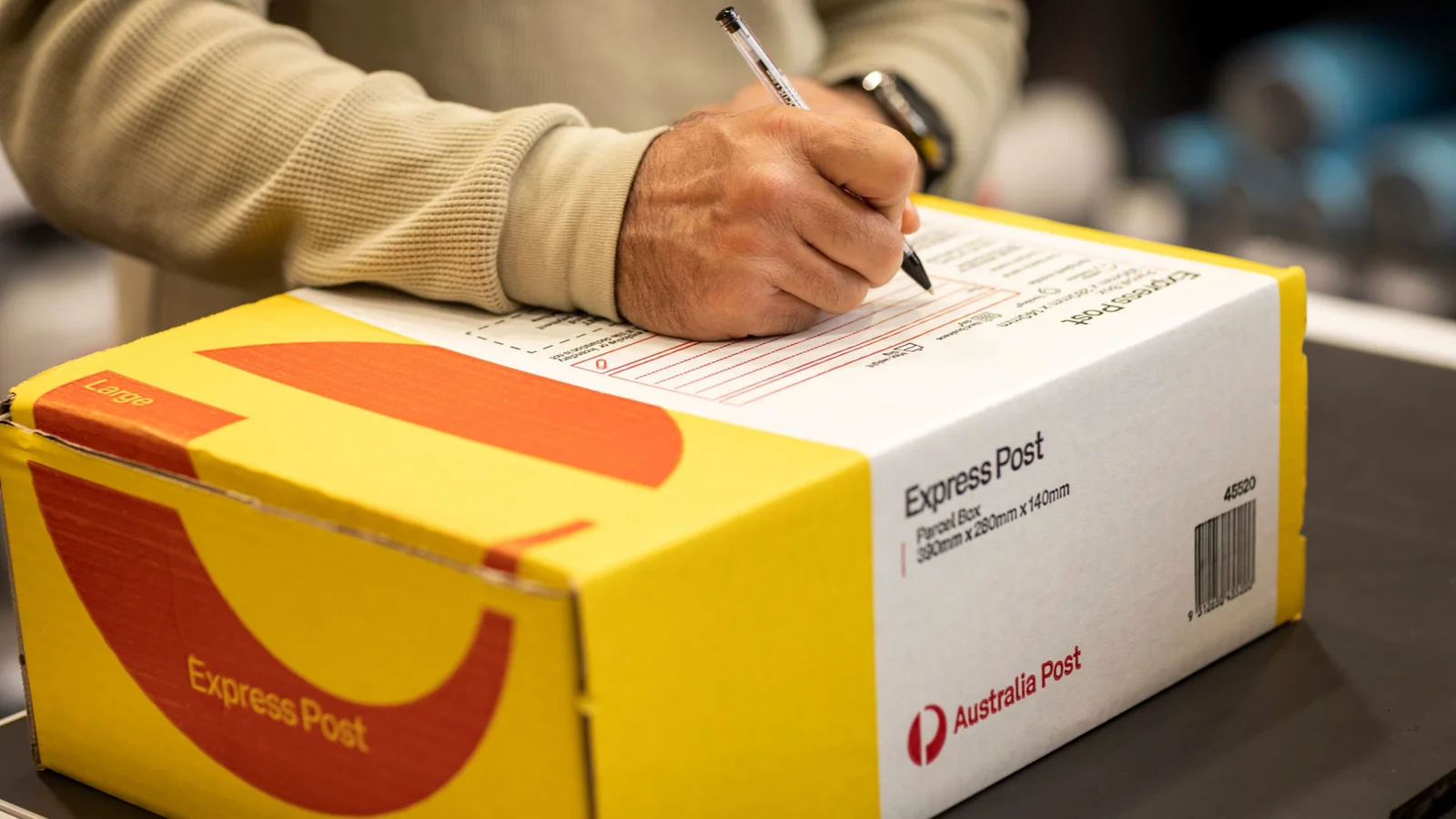 photo-man-signing-express-post-box